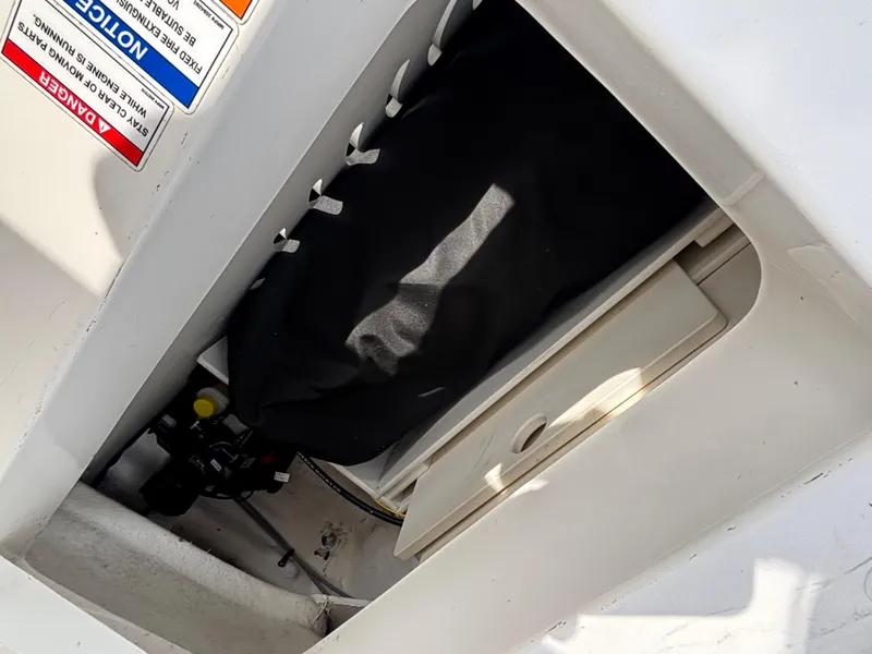 Slide: The Image of Storage compartment of a 2021 Sea Ray SPX 230 boat, showing interior details. - 27