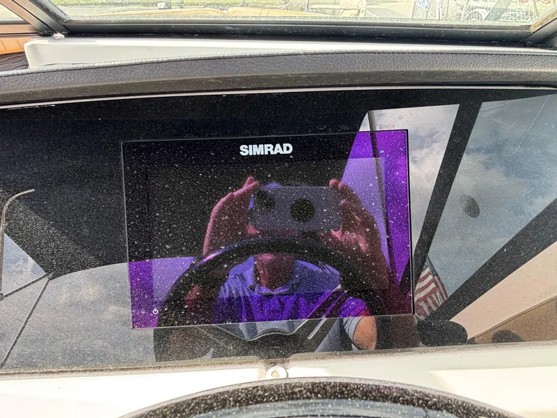 Slide: The Image of Simrad display on 2021 Sea Ray SPX 230 boat dashboard, reflecting surroundings. - 30