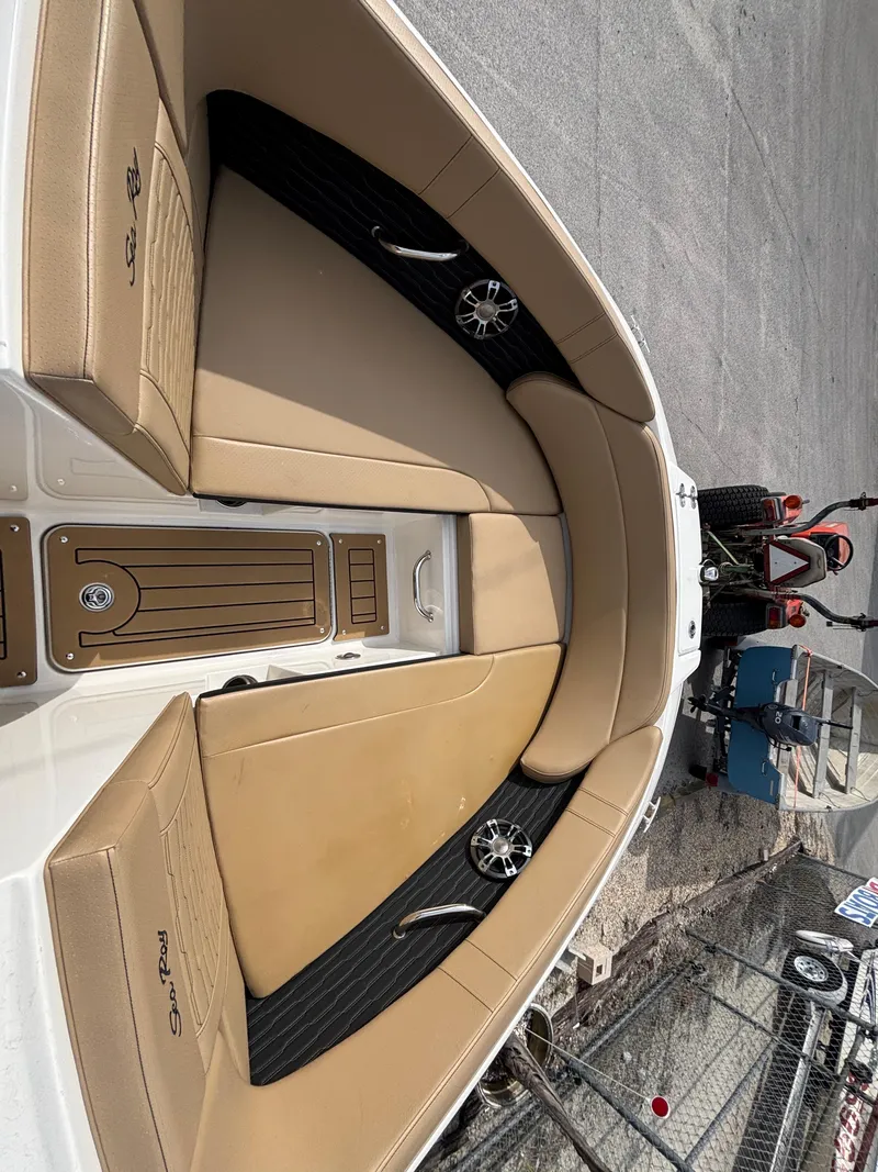 Slide: The Image of 2021 Sea Ray SPX 230 boat interior with tan seating and sleek design. - 32