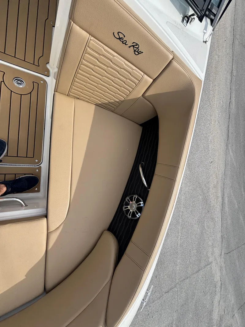 Slide: The Image of 2021 Sea Ray SPX 230 boat interior with tan seating and speaker detail. - 33