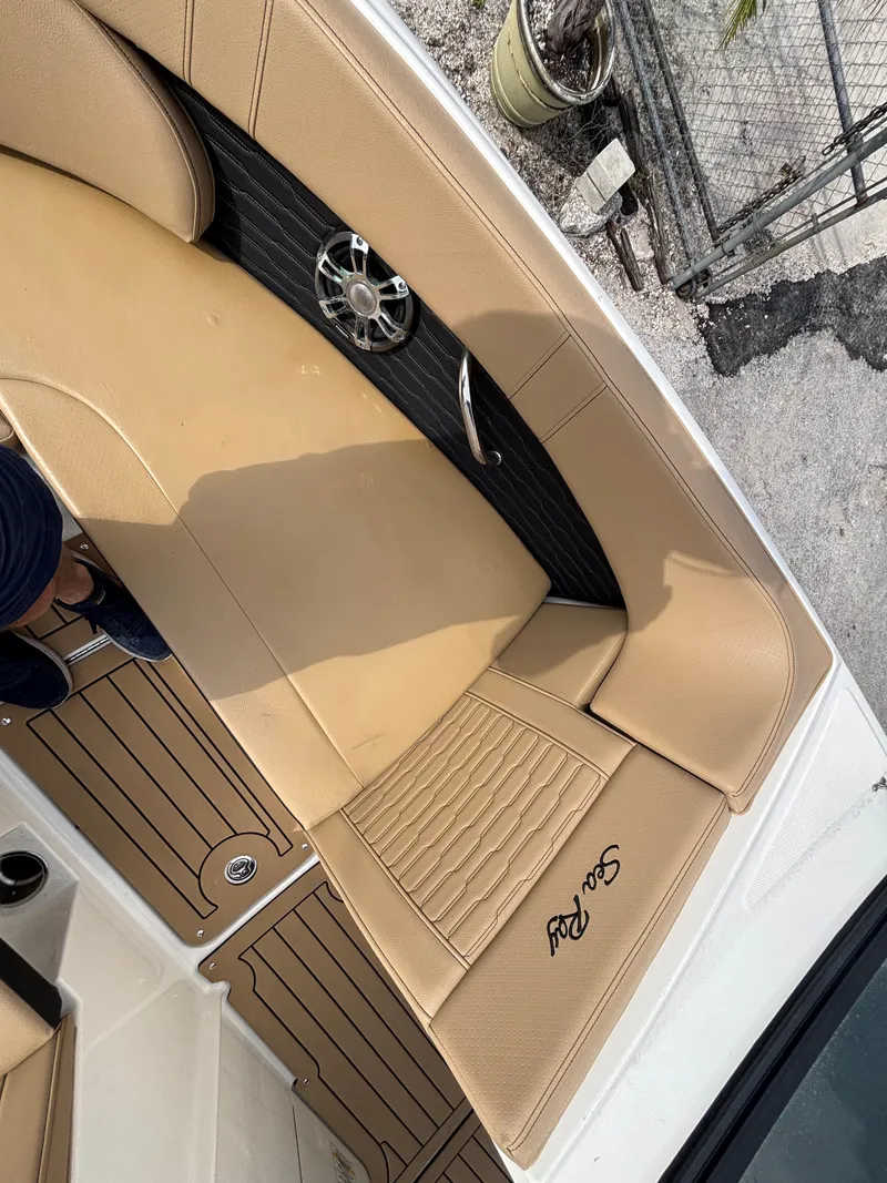 Slide: The Image of 2021 Sea Ray SPX 230 boat with tan leather seating and sleek design. - 34