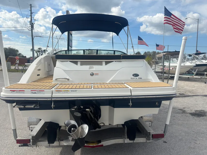 Slide: The Image of 2021 Sea Ray SPX 230 boat on trailer, rear view with American flags. - 5
