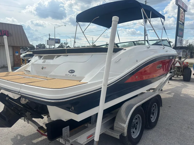 Slide: The Image of 2021 Sea Ray SPX 230 boat on trailer, featuring sleek design and canopy. - 6