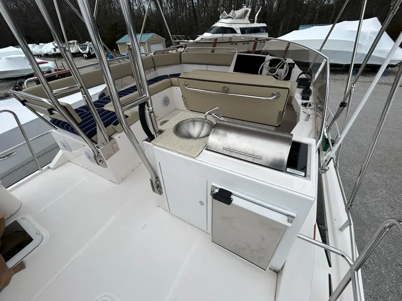 Slide: The Image of 2023 Ranger Tugs R-43 CB boat deck with sink and seating area. - 12