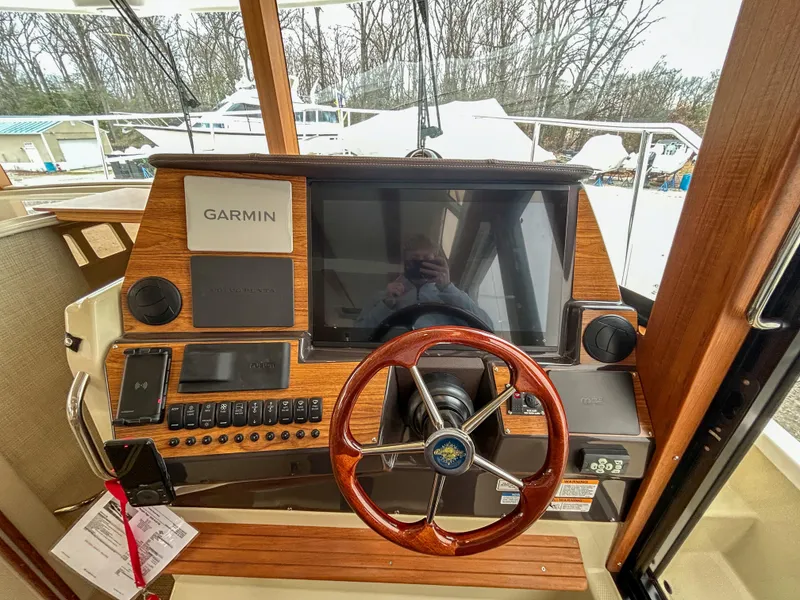 Slide: The Image of 2023 Ranger Tugs R-43 CB helm with Garmin navigation system and wooden steering wheel. - 18