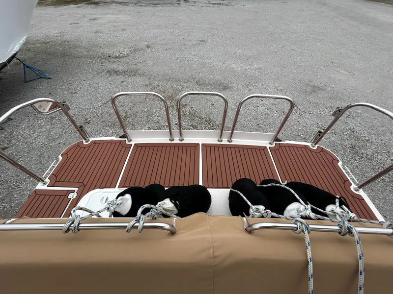 Slide: The Image of 2023 Ranger Tugs R-43 CB swim platform with teak decking and stainless steel railings. - 2