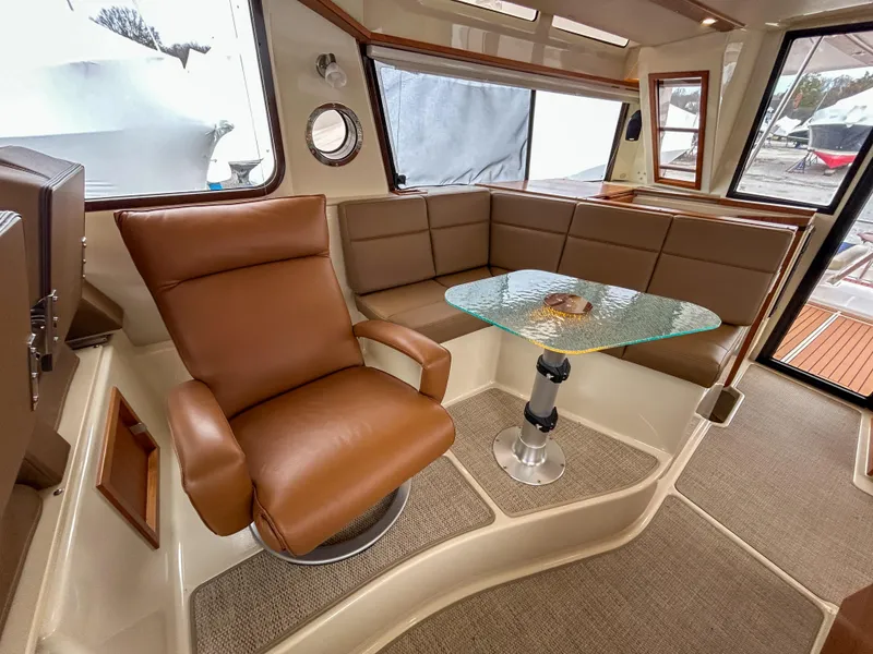 Slide: The Image of 2023 Ranger Tugs R-43 CB interior with leather seating and glass table. - 20