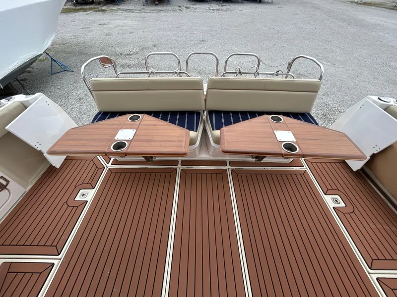 Slide: The Image of 2023 Ranger Tugs R-43 CB boat deck with wooden flooring and foldable tables. - 4