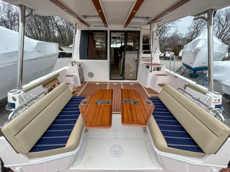 Slide: The Image of 2023 Ranger Tugs R-43 CB boat interior with seating and wooden tables. - 6