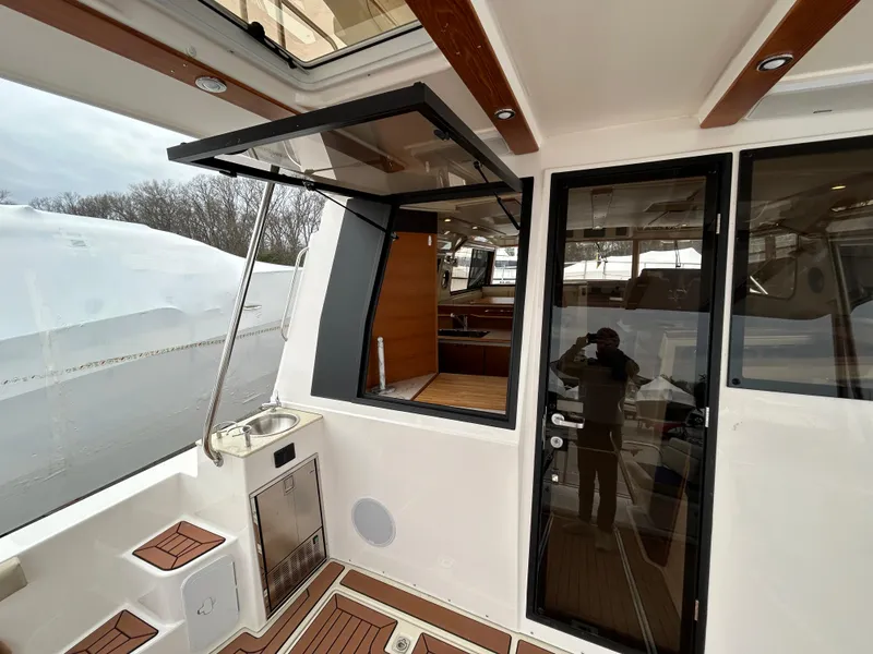 Slide: The Image of 2023 Ranger Tugs R-43 CB yacht interior with open window and sleek design. - 7