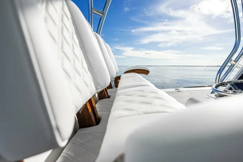 Slide: The Image of 2025 Valhalla Boatworks V-29 Hybrid interior with white seating, ocean view. - 19