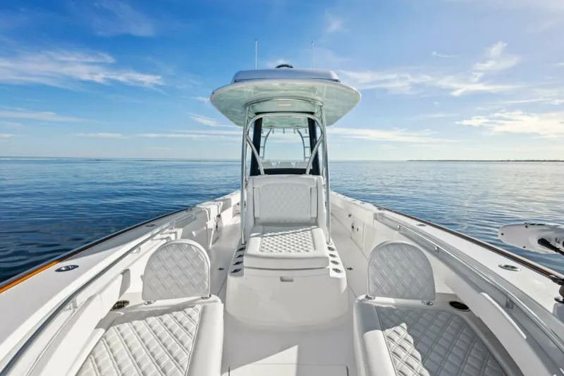Slide: The Image of 2025 Valhalla Boatworks V-29 Hybrid on calm ocean waters, showcasing sleek design and luxury seating. - 30