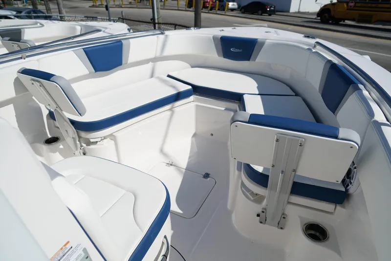 Slide: The Image of 2025 Robalo R232 EX boat interior with blue and white seating, showcasing modern design. - 19