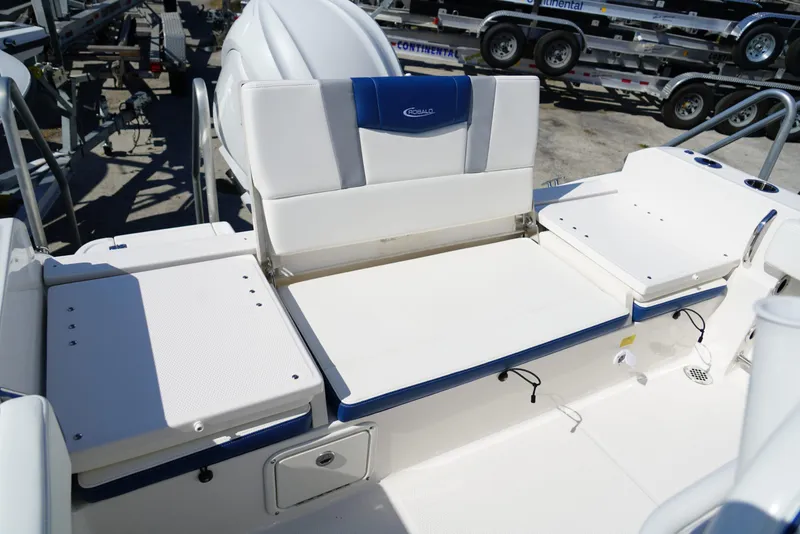 Slide: The Image of 2025 Robalo R232 EX boat interior with white seating and storage compartments. - 21