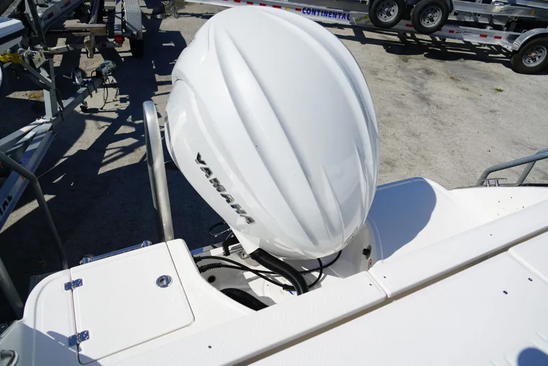Slide: The Image of 2025 Robalo R232 EX boat with Yamaha outboard engine, parked on a trailer. - 25