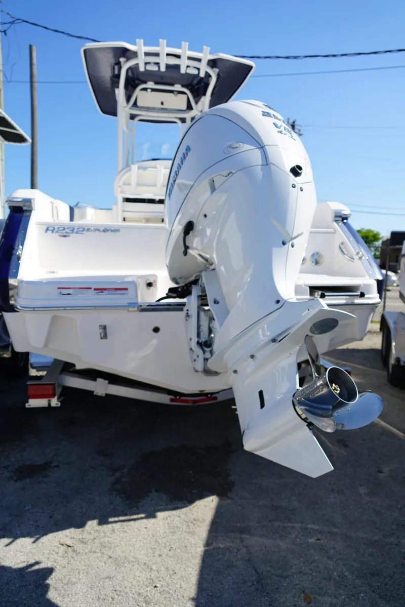 Slide: The Image of 2025 Robalo R232 EX boat with powerful outboard motor, rear view. - 26