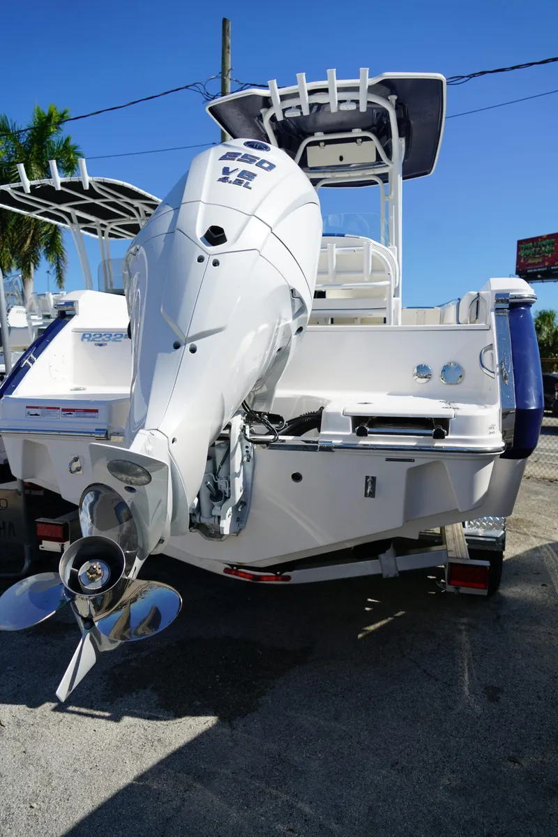 Slide: The Image of 2025 Robalo R232 EX boat with powerful outboard motor, displayed outdoors. - 27