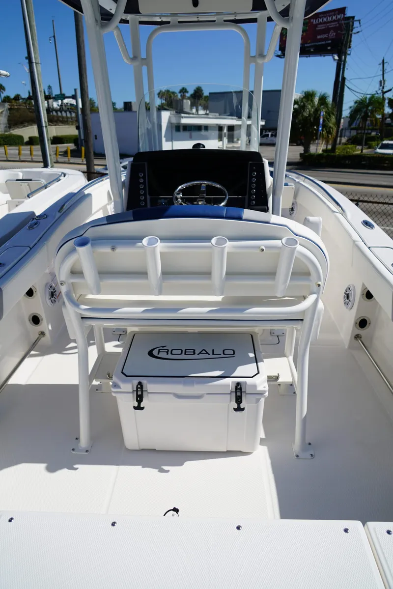 Slide: The Image of 2025 Robalo R232 EX boat interior with helm and seating area. - 6
