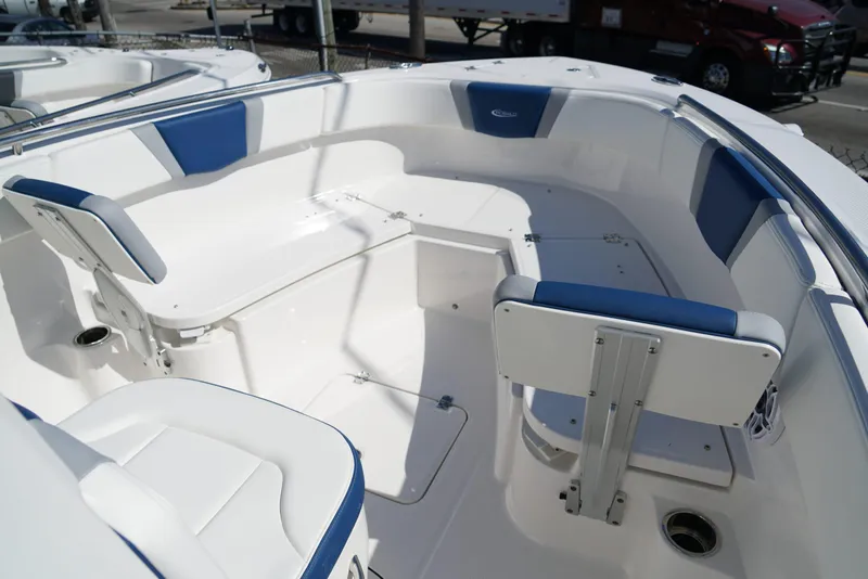 Slide: The Image of 2025 Robalo R232 EX boat interior with white and blue seating. - 9
