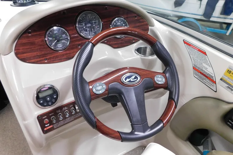 Slide: The Image of Steering wheel and dashboard of 2007 Sea Ray 220 Sundeck boat. - 14