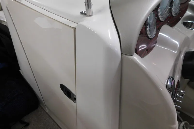 Slide: The Image of 2007 Sea Ray 220 Sundeck dashboard and storage compartment detail. - 16
