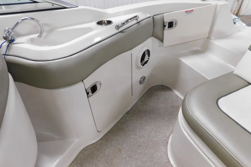 Slide: The Image of 2007 Sea Ray 220 Sundeck interior with seating, storage, and sink. - 21