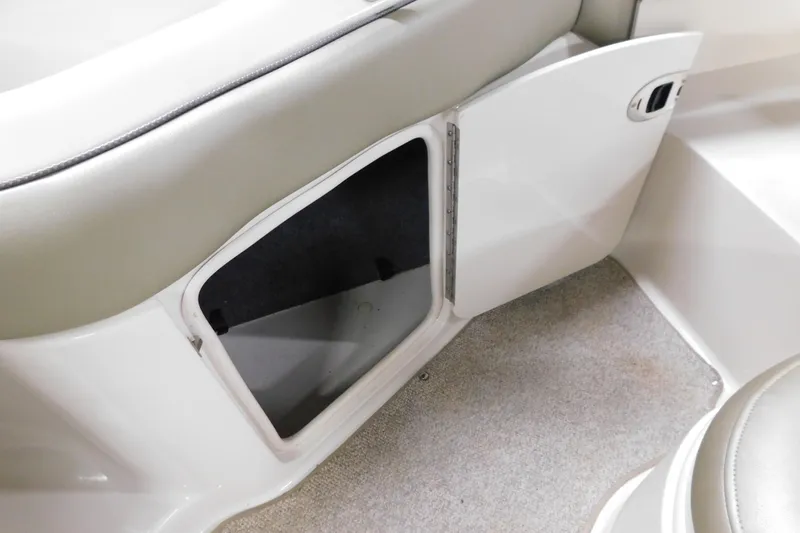 Slide: The Image of Open storage compartment on 2007 Sea Ray 220 Sundeck boat interior. - 23