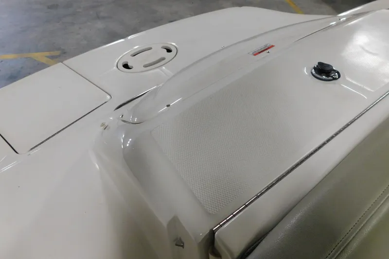 Slide: The Image of 2007 Sea Ray 220 Sundeck boat deck, featuring sleek design and storage compartment. - 25