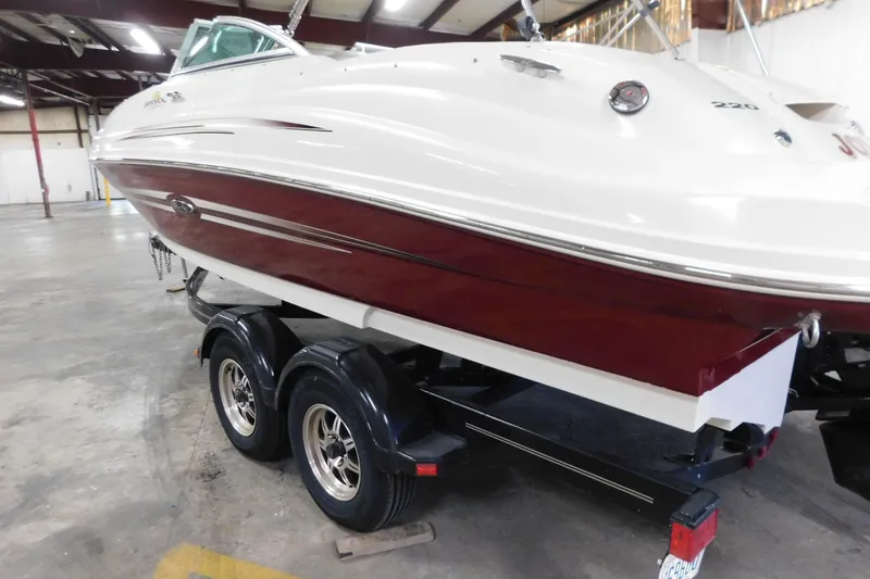 Slide: The Image of 2007 Sea Ray 220 Sundeck boat on trailer in indoor storage facility. - 26