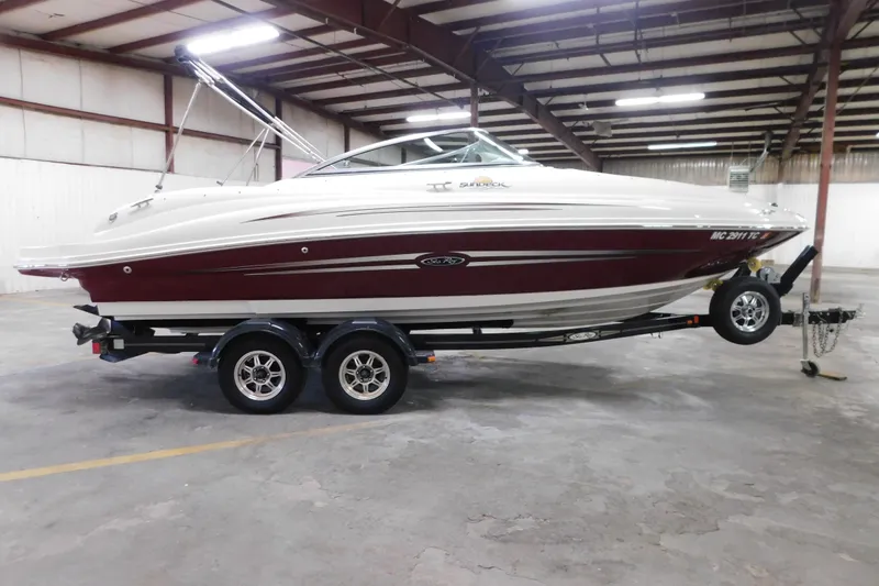 Slide: The Image of 2007 Sea Ray 220 Sundeck boat on trailer in indoor storage facility. - 28