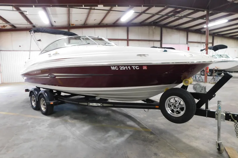 The Image of 2007 Sea Ray 220 Sundeck boat on trailer in indoor storage facility. - 3