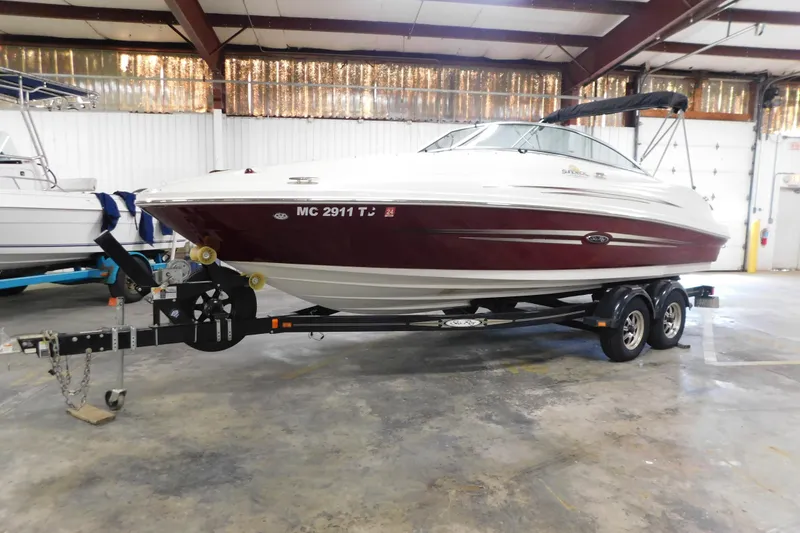 Slide: The Image of 2007 Sea Ray 220 Sundeck boat on trailer in indoor storage facility. - 4