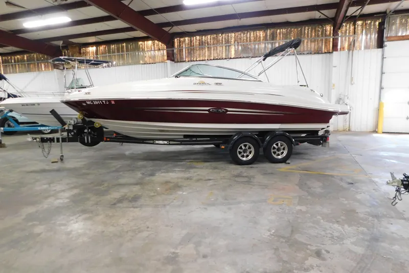 Slide: The Image of 2007 Sea Ray 220 Sundeck boat on trailer in indoor storage facility. - 5