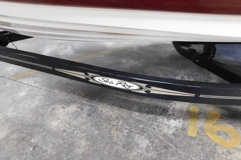 Slide: The Image of 2007 Sea Ray 220 Sundeck boat trailer with logo in parking space. - 9
