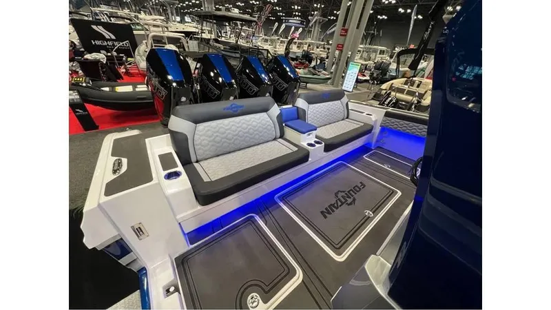 Slide: The Image of 2025 Fountain 43 SCX boat interior with seating and illuminated deck at a boat show. - 13