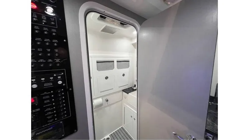 Slide: The Image of Interior of 2025 Fountain 43 SCX boat, featuring a modern cabin with control panels. - 25