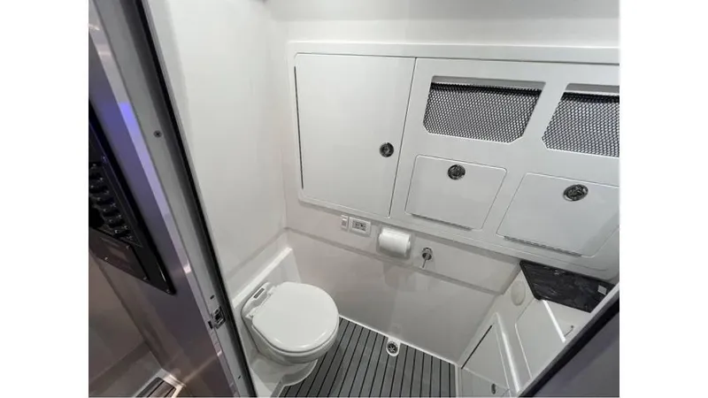 Slide: The Image of 2025 Fountain 43 SCX boat bathroom with modern fixtures and storage cabinets. - 26