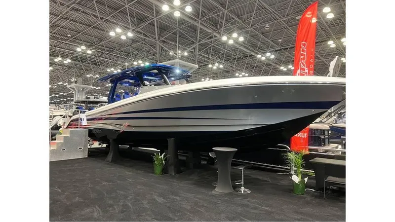 Slide: The Image of 2025 Fountain 43 SCX boat displayed at an indoor exhibition with bright overhead lighting. - 6