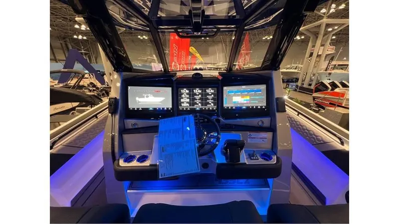 Slide: The Image of 2025 Fountain 43 SCX boat cockpit with advanced navigation screens and illuminated controls. - 8