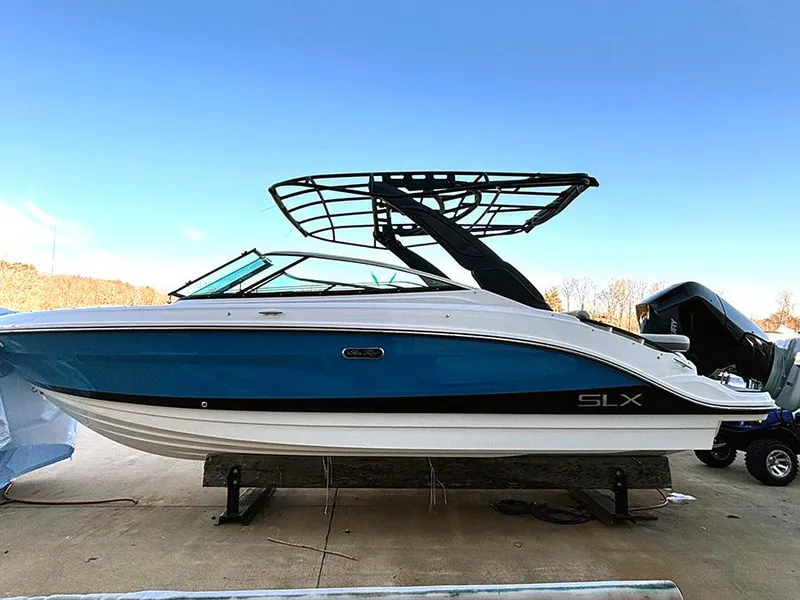 The Image of 2025 Sea Ray SLX 260 Outboard boat with sleek blue and white design. - 0