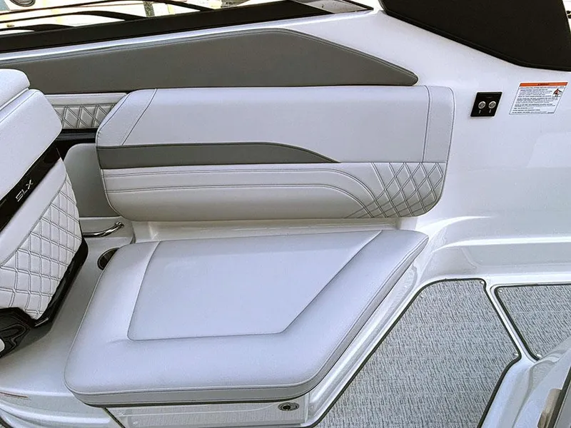 Slide: The Image of 2025 Sea Ray SLX 260 Outboard interior with luxurious white seating and modern design. - 11