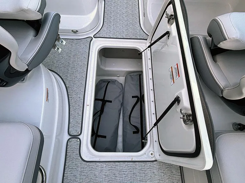 Slide: The Image of 2025 Sea Ray SLX 260 Outboard boat storage compartment with open hatch and interior view. - 18