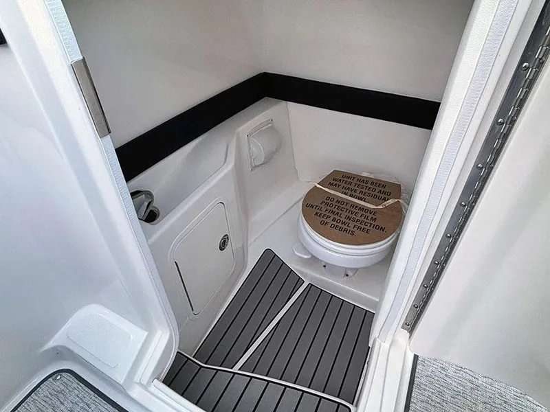 Slide: The Image of 2025 Sea Ray SLX 260 Outboard boat bathroom with modern design and sleek flooring. - 20