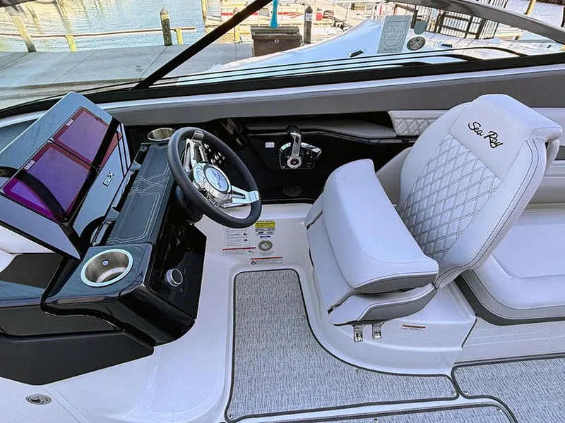 Slide: The Image of 2025 Sea Ray SLX 260 Outboard cockpit with luxury seating and modern controls. - 21