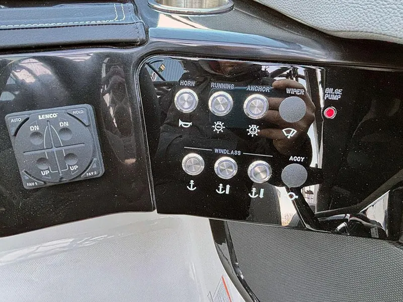 Slide: The Image of Control panel of 2025 Sea Ray SLX 260 Outboard with various switches and indicators. - 24