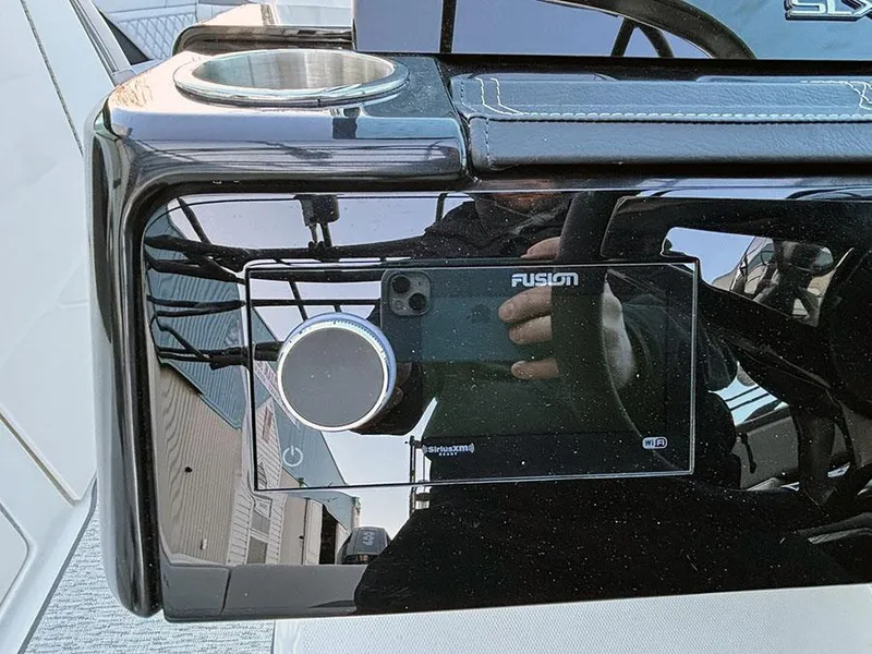 Slide: The Image of Control panel of 2025 Sea Ray SLX 260 Outboard with Fusion audio system. - 26