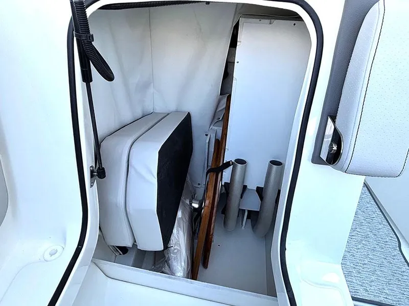 Slide: The Image of Storage compartment in 2025 Sea Ray SLX 260 Outboard boat, featuring organized interior space. - 34