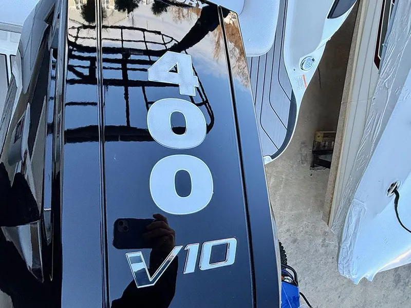 Slide: The Image of Close-up of 2025 Sea Ray SLX 260 Outboard engine, featuring 400 V10 markings. - 5