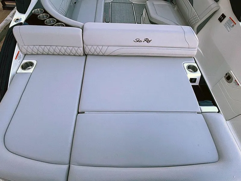 Slide: The Image of 2025 Sea Ray SLX 260 Outboard boat with luxurious seating and cup holders. - 6