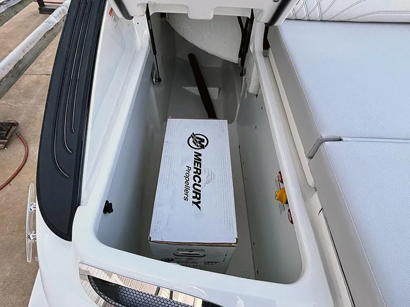 Slide: The Image of 2025 Sea Ray SLX 260 Outboard storage compartment with Mercury propellers box. - 7
